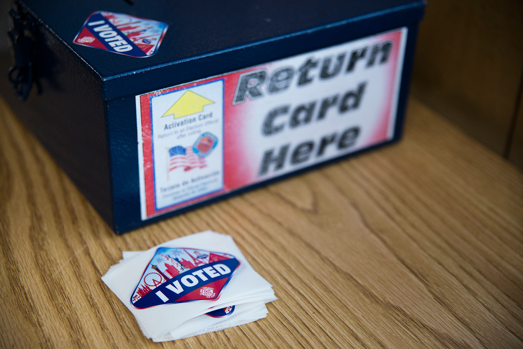 After casting their ballots, voters in Clark County deposit the cards they use to vote in this box and receive an “I voted” sticker that resembles the Las Vegas welcome sign. (Roman Knertser/News21)
