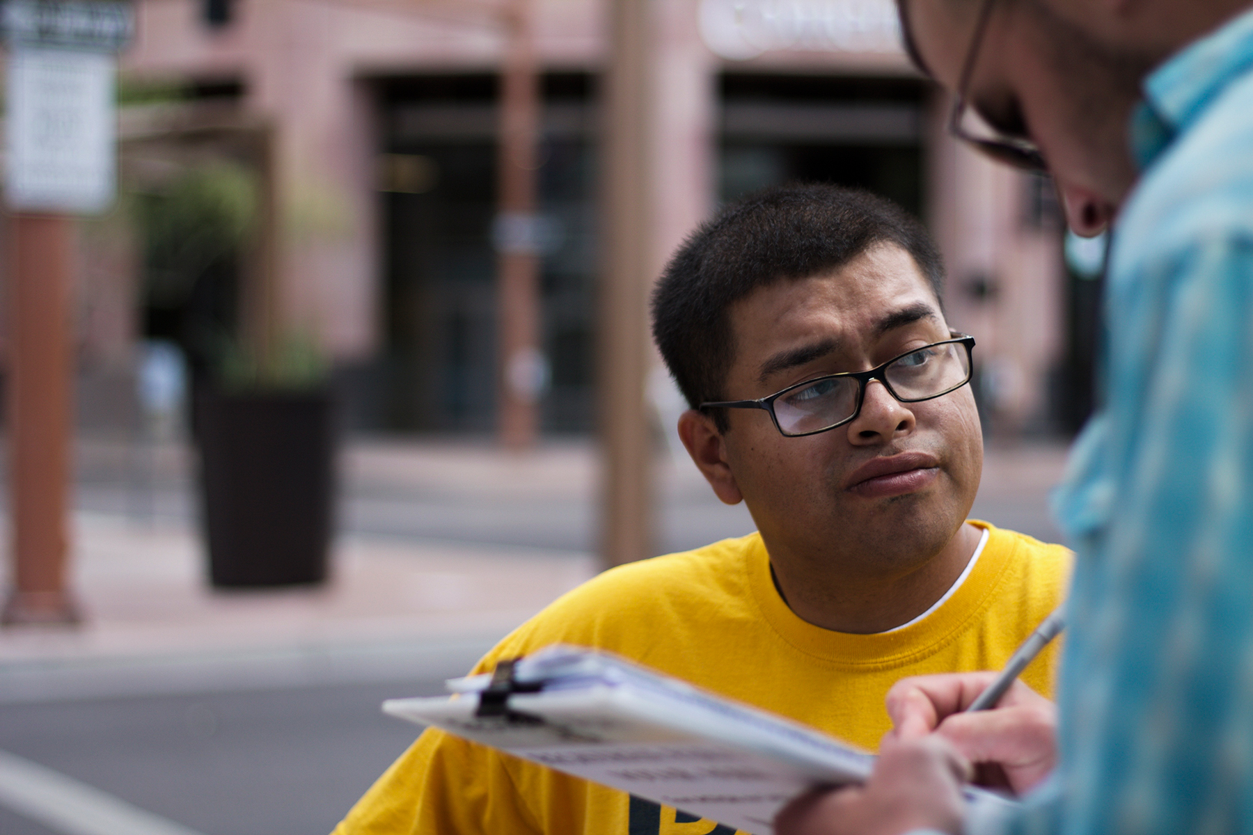 Jose Barboza, a Promise Arizona volunteer, registers voters in Phoenix. Thirteen cases of double voting were prosecuted in the state since 2012. (Courtney Columbus/News21)