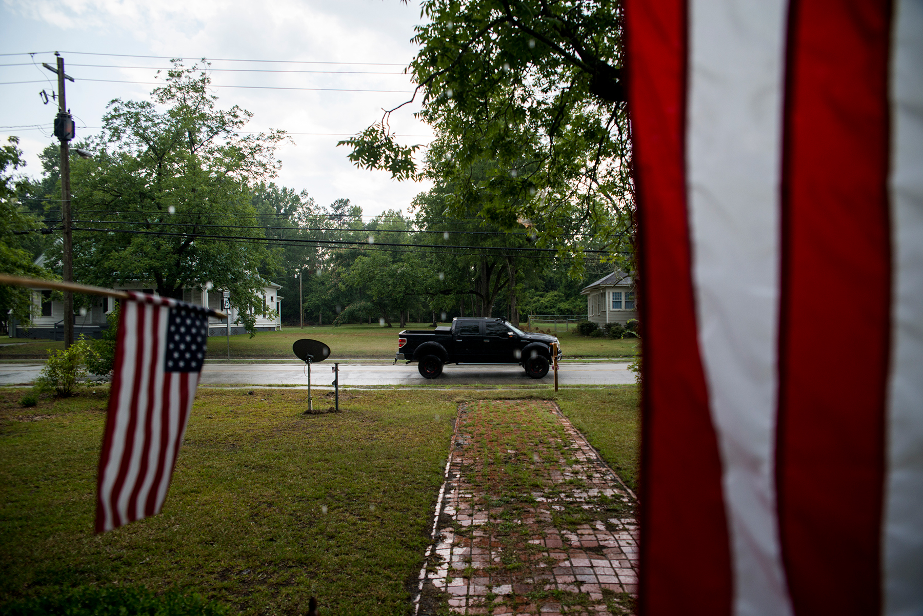 Residents in Sparta, Georgia, display American flags from their front porch on July 3. The Center for American Progress Action Fund gives Georgia low marks for ballot accessibility. (Roman Knertser/News21)