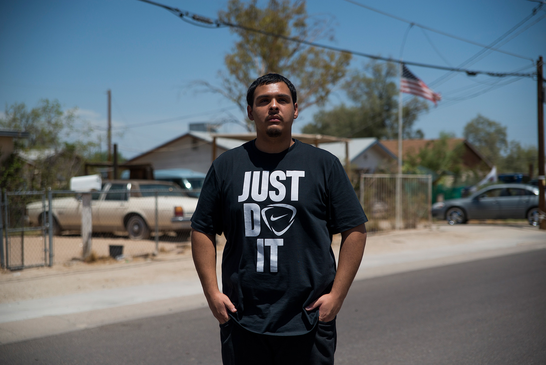 David Castorena, 24, of Chandler, Arizona, stands in the street of a small, largely Latino community in Arizona where he attends church. Castorena said he does not plan to vote in the November election because he thinks Donald Trump will win either way. (Roman Knertser/News21)