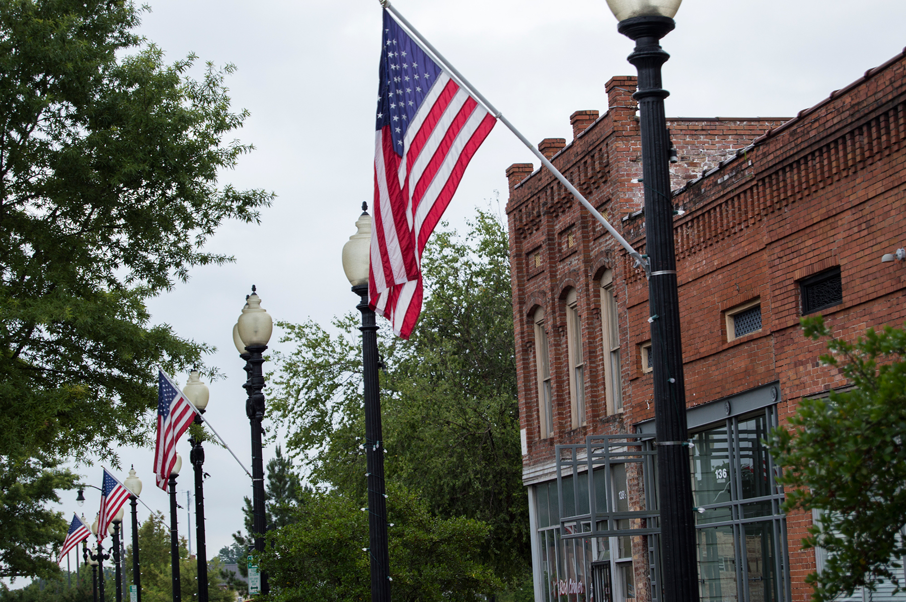 A row of flags greets pedestrians on Person Street in downtown Fayetteville, home to a considerable population of active duty military personnel and veterans. (Michael Olinger/News21)