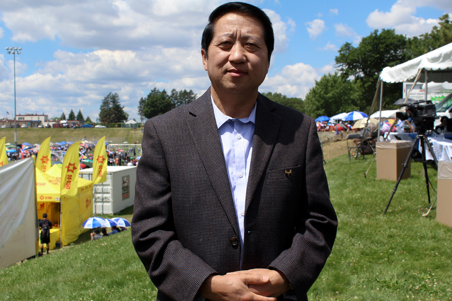 Wahoua Vue, president of the Hmong 18 Council Inc., stands outside of the Hmong festival in St. Paul, Minnesota. The council began as a nonprofit group focused on community culture, but it also is educating Hmong people about voting. (Phillip Jackson/News21)
