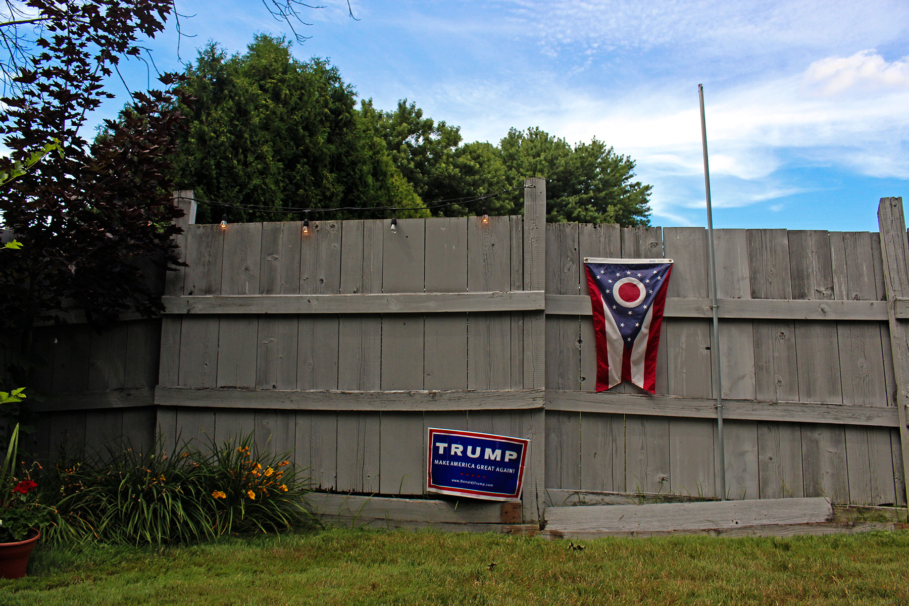 A Donald Trump campaign sign and Ohio state flag decorate the backyard of Kathy Miller, the Mahoning County chairwoman for Trump, in Boardman, Ohio. Miller is leading a grassroots movement encouraging Democratic voters to vote for Trump in November’s general election. (Emily Mills/News21)