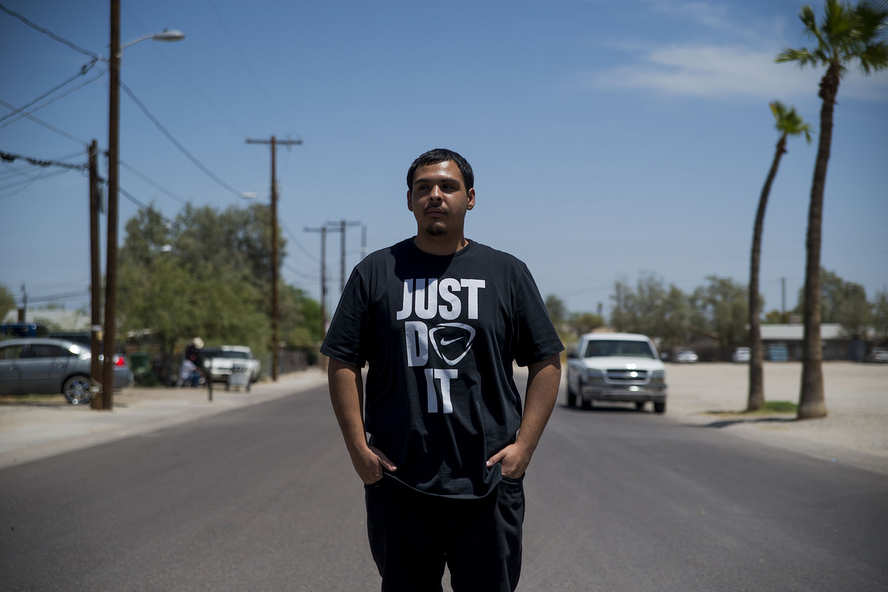 David Castorena, 24, of Chandler, Arizona, stands in the street of a small, largely-Latino community where he attends church. Castorena does not plan to vote in the November election because he thinks Donald Trump will win either way. (Roman Knertser/News21)