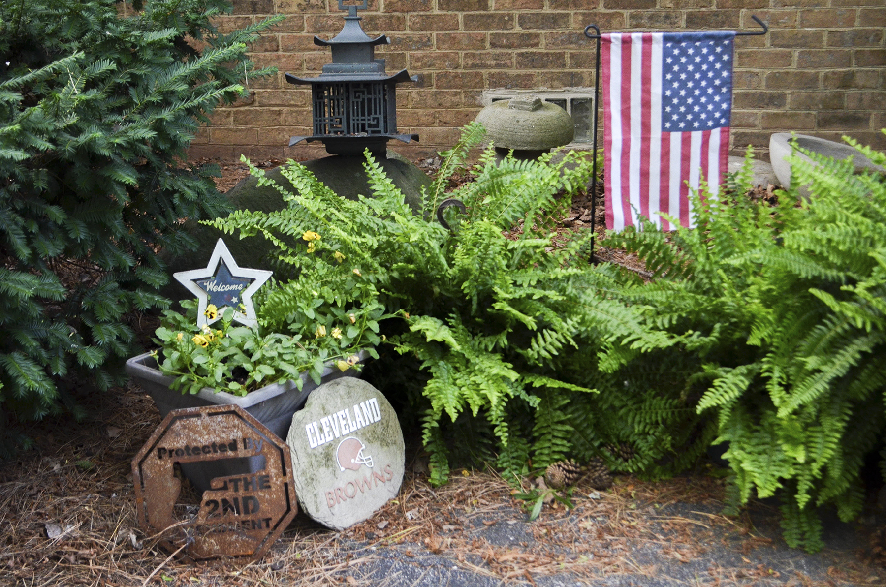 Kathy Miller, the Mahoning County chairwoman for Donald Trump, decorated her garden in Boardman, Ohio, with a pro-gun-rights sign, a Cleveland Browns sign and an American flag. She said people are fed up with the direction of the country and are looking to Trump for change. (Lian Bunny/News21)
