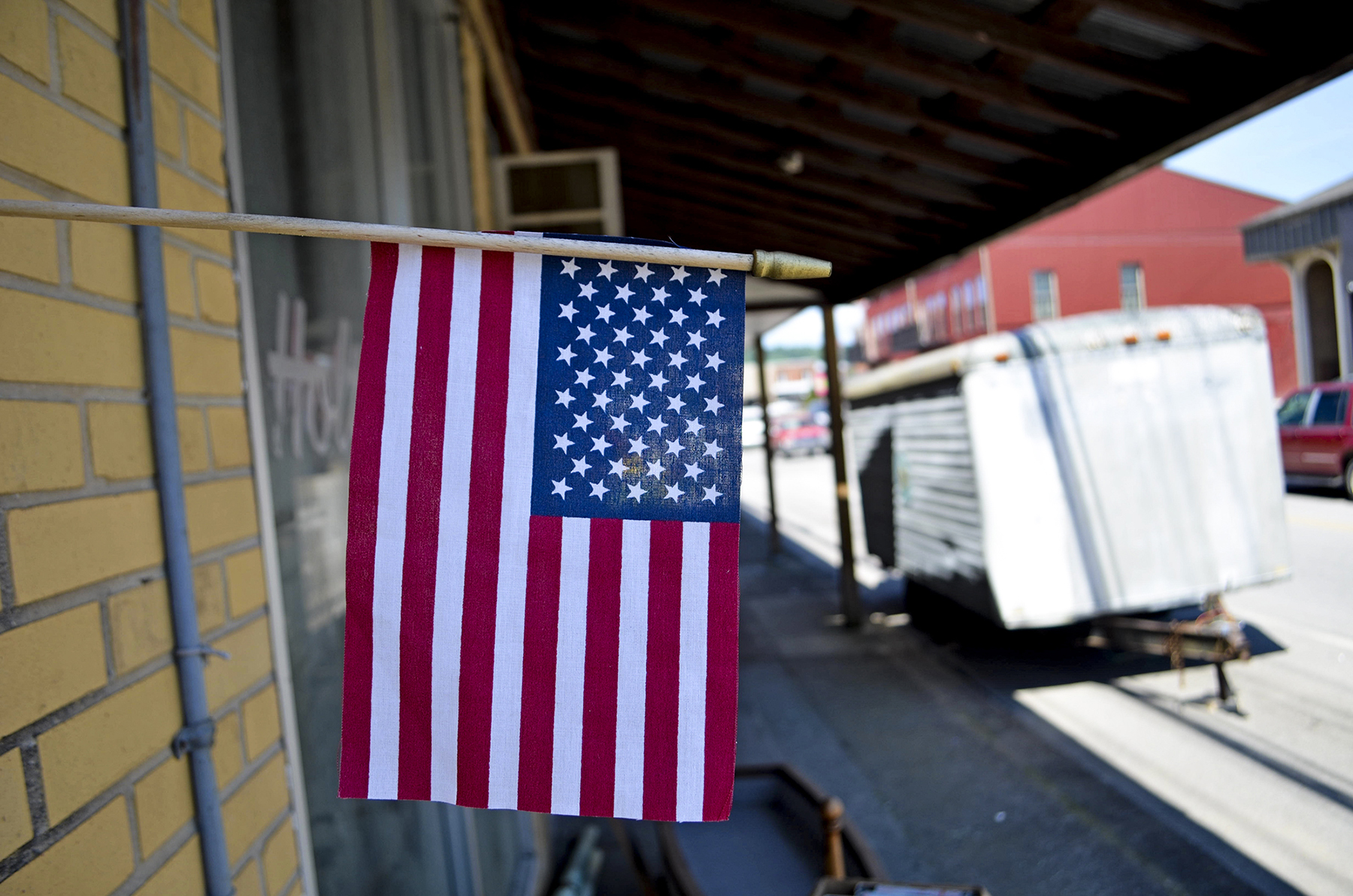 An American flag decorates a Clay County, Tennessee, street of empty buildings and economically struggling small businesses. The county has a 24 percent poverty rate. (Lian Bunny/News21)