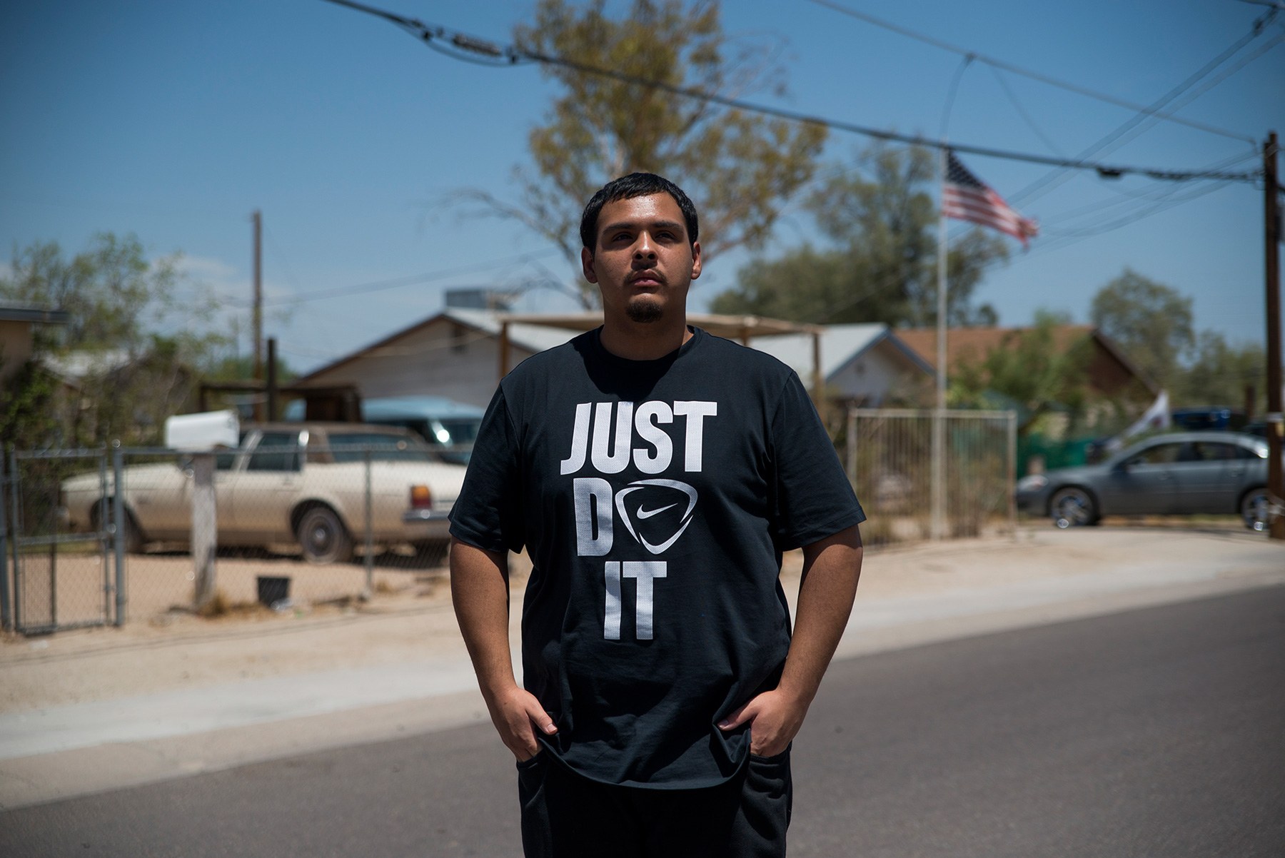 David Castorena, 24, of Chandler, Arizona, stands in the street of a small, largely Latino community in Arizona where he attends church. Castorena said he does not plan to vote in the November election because he thinks Donald Trump will win either way. (Roman Knertser/News21)