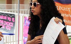 Teresa Martinez, voting rights ambassador for the Arizona Secretary of State, explains the information on a voter registration form to several high school students at a mock election event on April 12, 2016. (Photo by Marianna Hauglie/News21)