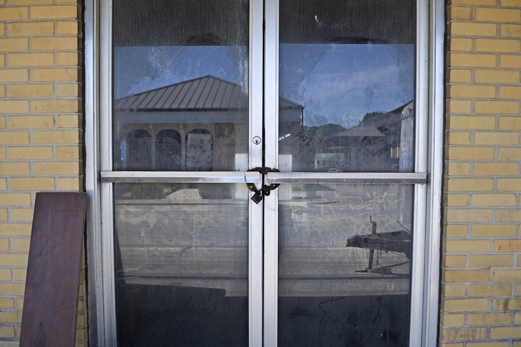 A lock and chain secure the door of Holt’s Variety Store in Celina, Tennessee. Holt’s is one of many closed storefronts in the city. (Lian Bunny/News21)
